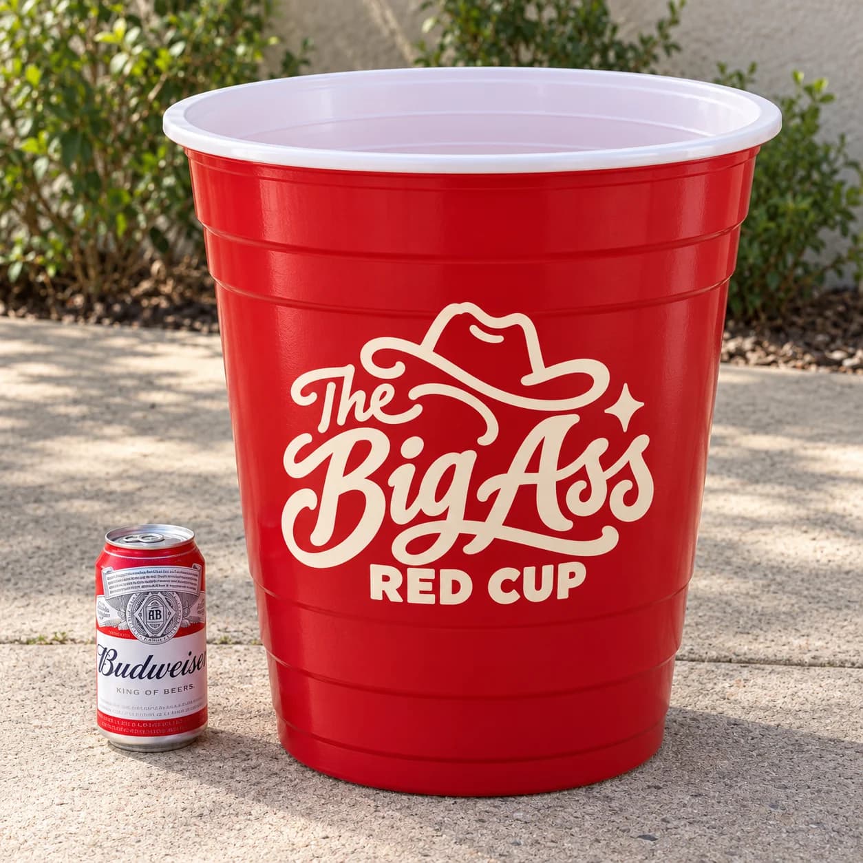 Large reusable red Big Ass Red Cup beside a normal beverage can.