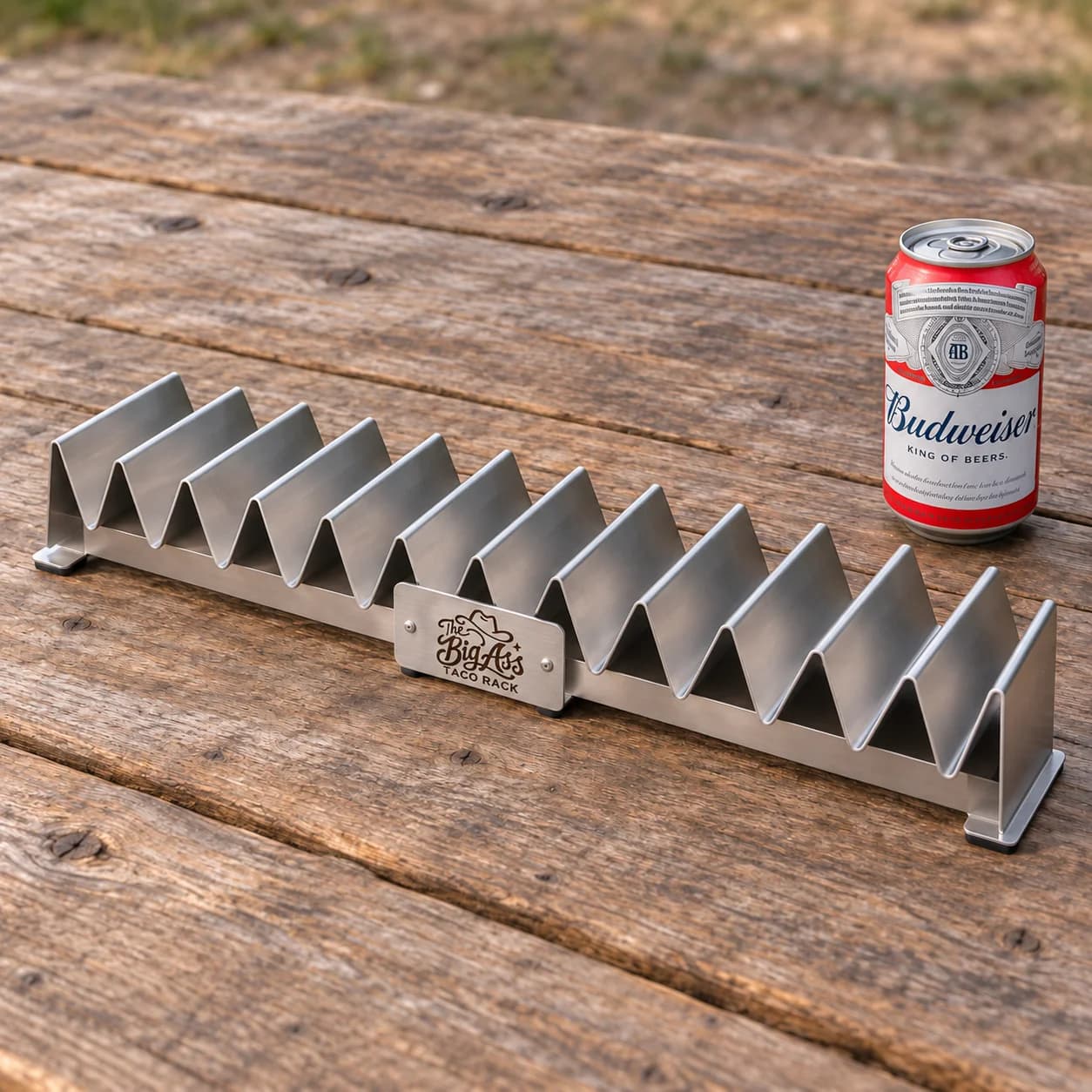 Long stainless Big Ass Taco Rack with repeated upright serving slots.