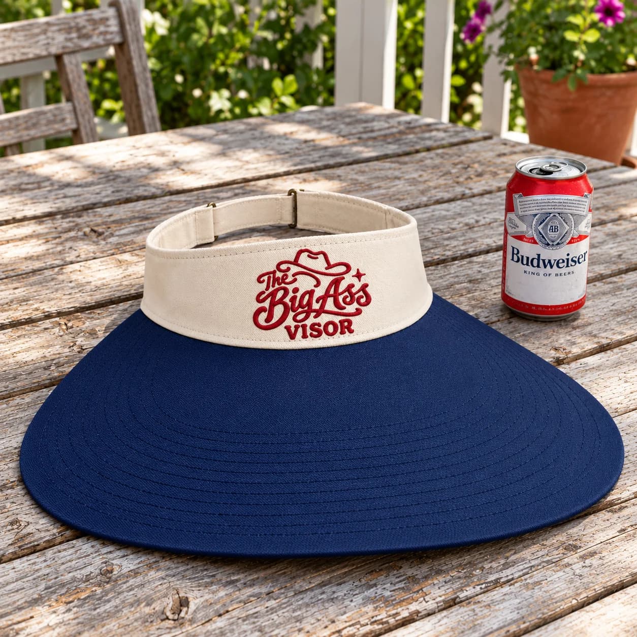 Branded visor with an extended curved bill and open crown.